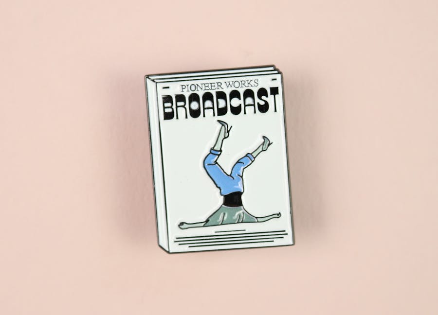 Broadcast magazine pin badge